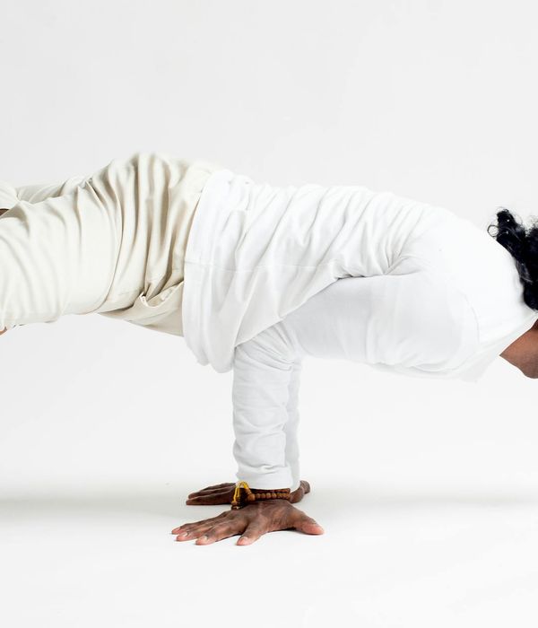 Person in a balancing yoga asana, showing focus and strength.